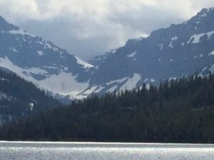 A glacier is showcased in a canyon bowl between two mountains.