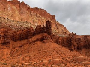 Cliffs and caves, spires and domes rise between the vibrantly colored canyon walls.