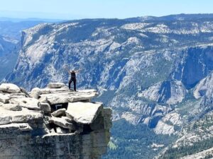 Climbing Half Dome in Yosemite is a strenuous 14–17 mile round-trip hike that requires a permit and involves a final, steep 400-foot ascent using two steel cables. The challenging trek includes a 4,800-foot elevation gain and takes 10–12 hours.